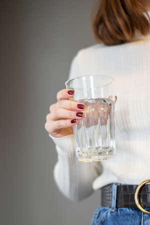 Mockup of female hand holding a coffee cup on office backgroundの写真素材