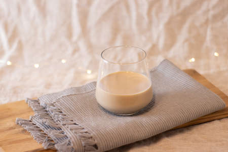 Mockup of female hand holding a coffee cup on office background