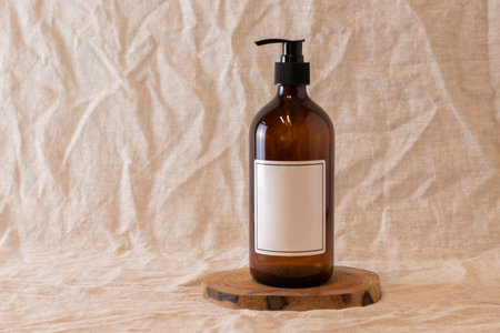 Empty amber glass soap or shampoo bottle on isolated background. Skin care or hair concept with natural cosmetics.の写真素材