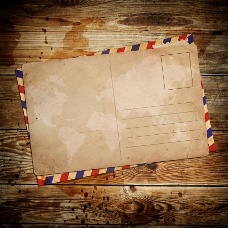 vintage postcard with envelop on wooden backgroundの写真素材