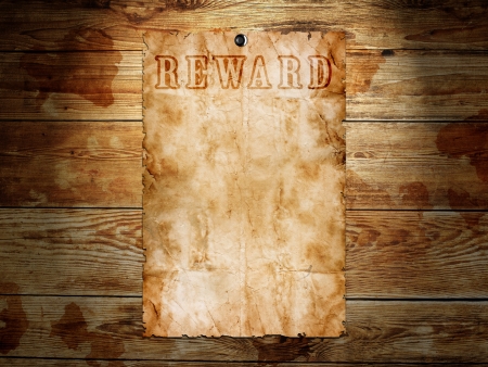 Old western wanted poster on wooden backgroundの写真素材