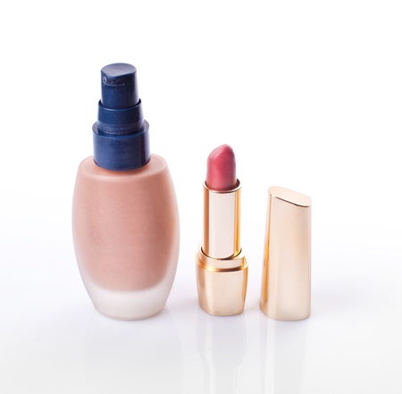 Cosmetic liquid foundation and pink lipstick isolated on white backgroundの写真素材