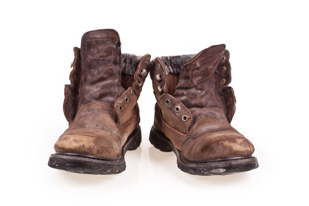 Dirty old boots isolated over white background