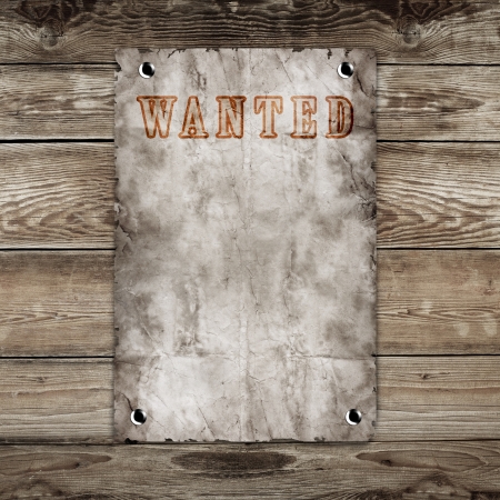 Old western wanted poster on wooden backgroundの写真素材
