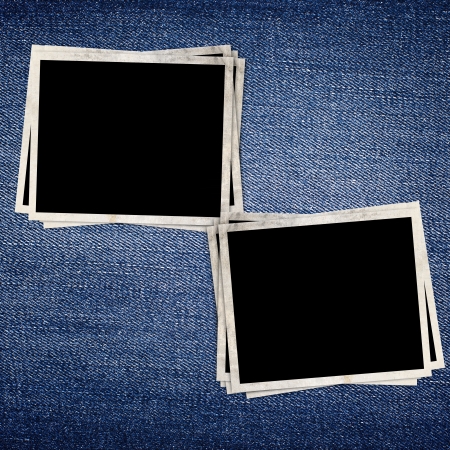 Vintage photo frame on blue jeans backgroundの写真素材