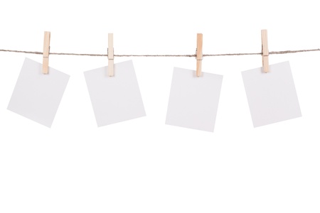 Blank instant photo hanging on the clothesline. Isolated on white backgroundの写真素材