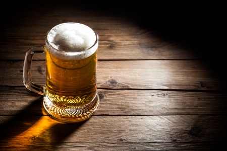 Mug of beer on wooden backgroundの写真素材