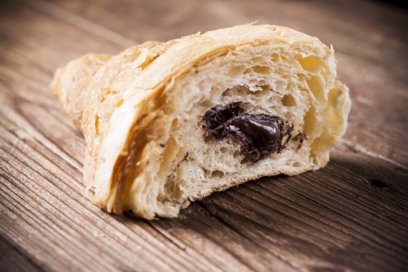 Fresh chocolate croissant on a wood backgroundの写真素材