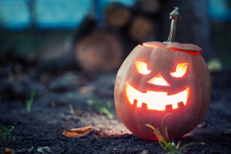 halloween jack-o-lantern standing on groundの写真素材