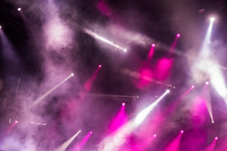 cheering crowd in front of bright stage lights の写真素材