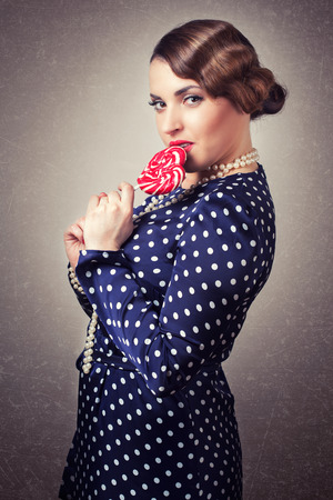 woman with big lollipop in retro styleの写真素材