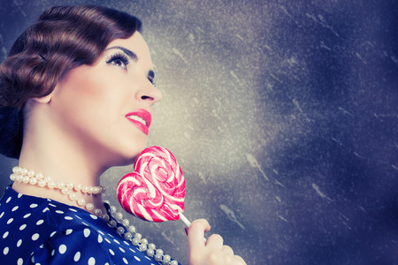 woman with big lollipop in retro style