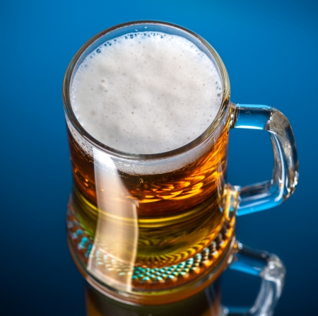 fresh beer on blue backgroundの写真素材