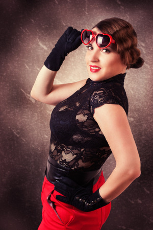 portrait of retro woman with heart-shaped glassesの写真素材