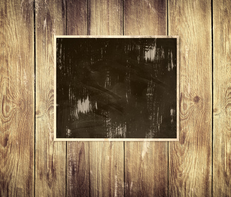 Blank photo frame on wooden wallの写真素材