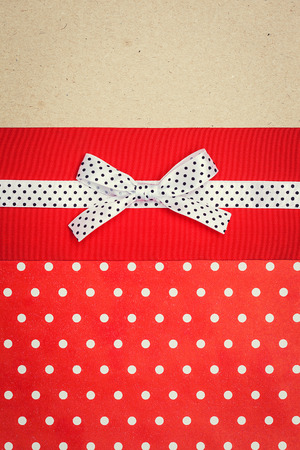 vintage background with polka dot paper, old paper and red and white polka dot ribbon with bowの写真素材
