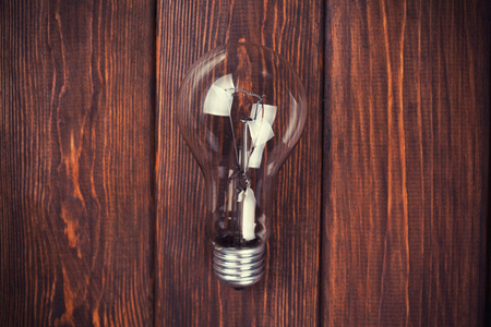 bulb on the brown wooden background の写真素材