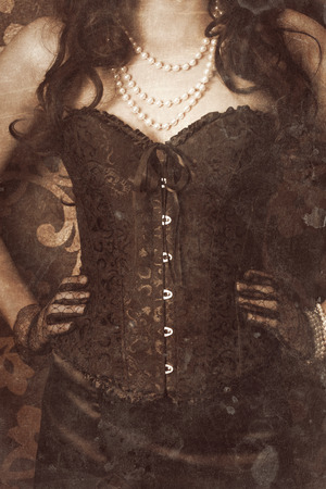 woman wearing black corset and pearls against retro backgroundの写真素材
