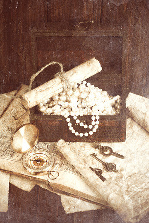 treasure chest, compass and old map on wooden tableの写真素材
