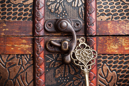 vintage key and old treasure chest on wooden table
