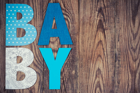 letters of word baby on wooden backgroundの写真素材