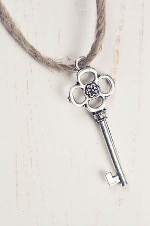 Vintage key on wooden background の写真素材