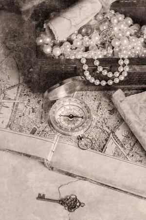 treasure chest, compass and old map on wooden tableの写真素材