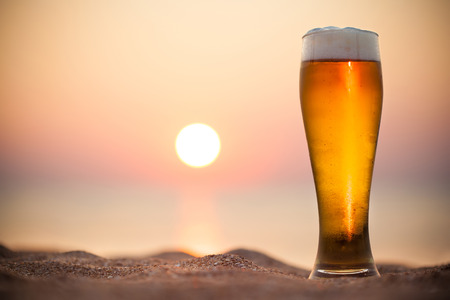Glass of beer on a sunset 
の写真素材