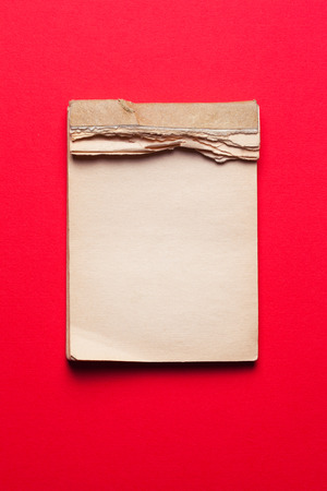 old notebook on red backgroundの写真素材