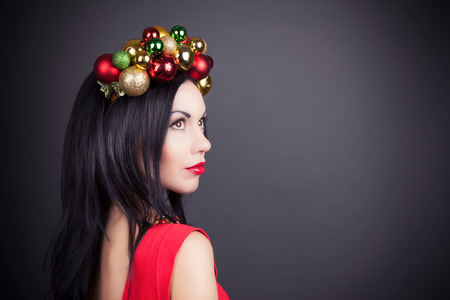 beautiful woman wearing a wreath made from Christmas decorationsの写真素材