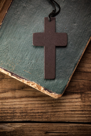 Closeup of wooden Christian cross on bibleの写真素材