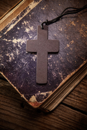 Closeup of wooden Christian cross on bibleの写真素材