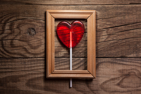 Lollipop heart on vintage wooden frame