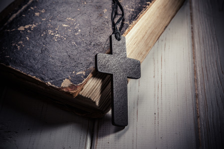 Closeup of wooden Christian cross on bibleの写真素材