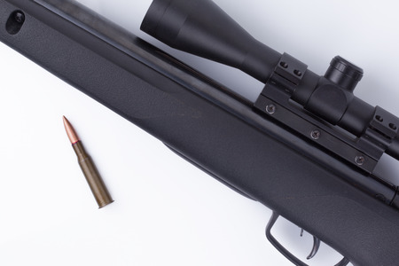 Close-up of riffle with bullets on white backgroundの写真素材