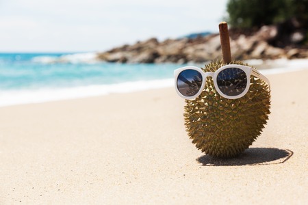 Durian a king of fruit in glasses, on the beachの写真素材