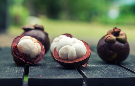 mangosteens on a wooden table, close up imageの写真素材