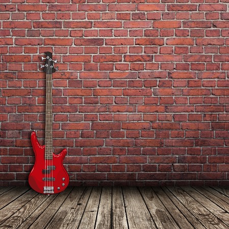 red electric guitar in the room with brick wall backgroundの写真素材