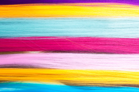 Color clip in hair extension, closeup on white