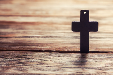 Old cross on a brown wood backgroundの写真素材