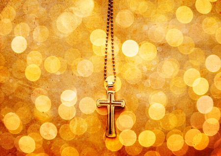 Closeup of silver Christian cross on bokeh backgroundの写真素材