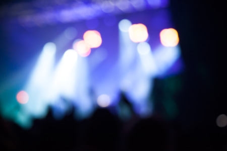 Silhouettes of people and musicians in big concert stage