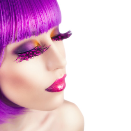 beautiful woman wearing colorful wig against white backgroundの写真素材