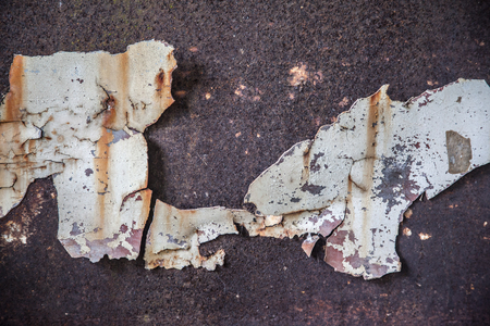 chipped metal plating on scratched wall , grunge backgroundの写真素材