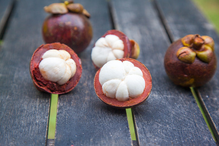 mangosteens on a wooden table, close up image