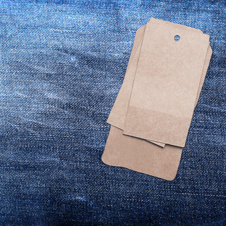blue jeans background with brown paper labelの写真素材
