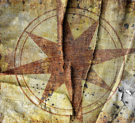 Old compass on canvas background with scratches and stainsの写真素材