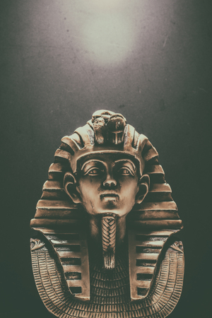 Stone pharaoh tutankhamen mask on dark backgroundの写真素材
