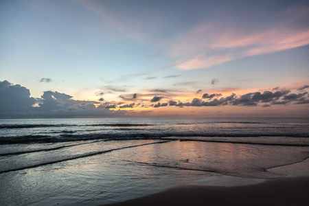 Beautiful orange sun rise with sea and cloudsの写真素材