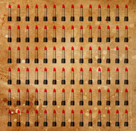 Background made from red lipsticks on a grunge backgroundの写真素材